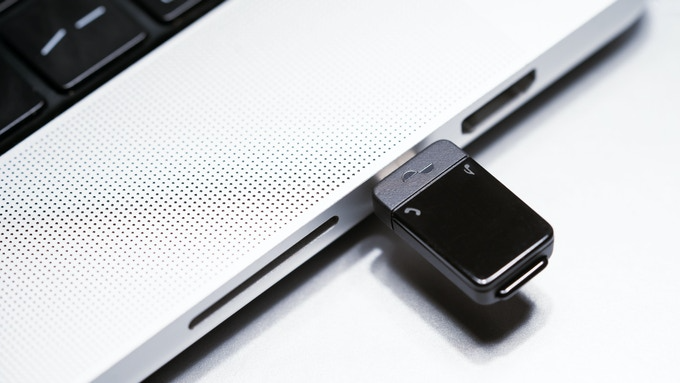 Nura Bluetooth® 5.3 Audio Transmitter inserted USB-C port of laptop